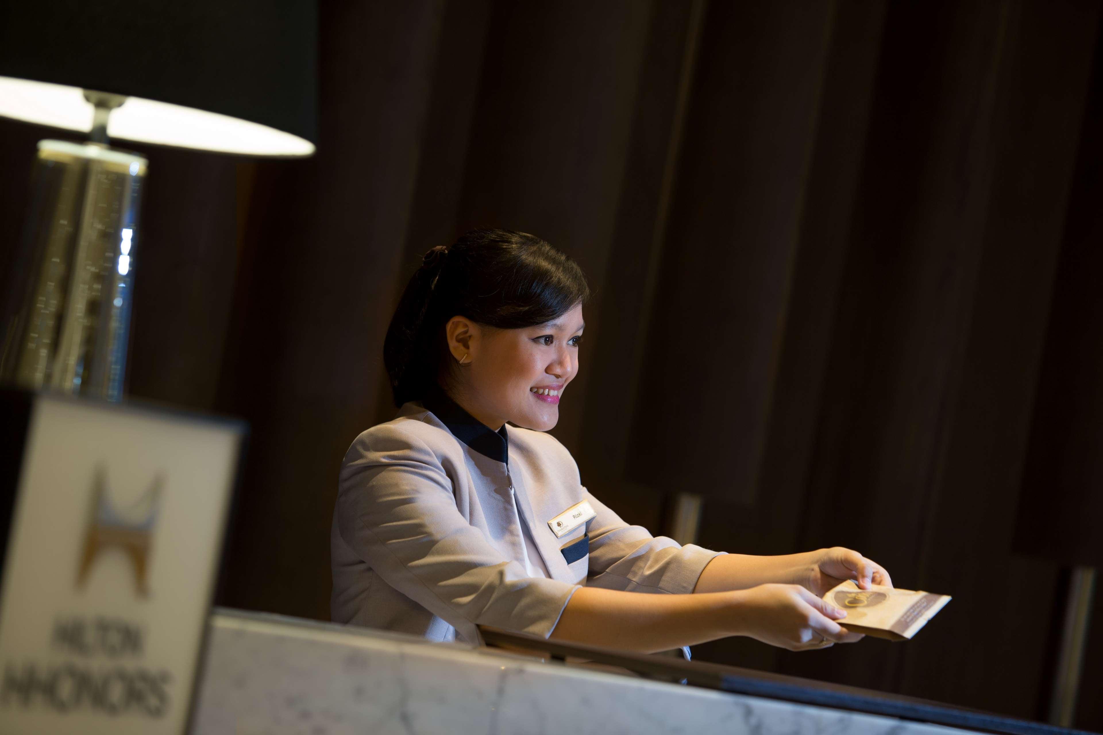 Doubletree By Hilton Jakarta - Diponegoro Exterior photo A hotel receptionist at work